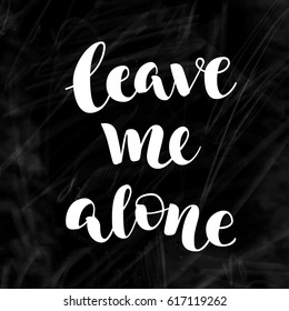 White vector lettering Leave me alone on chalk blackboard. Handwritten modern calligraphy. Inscription for postcards, posters, prints, greeting cards, t-shirts.