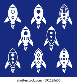 White vector rocket icons collection on blue background