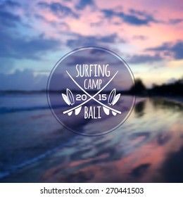 White vector surfing camp logo on blurred ocean sunset photo background