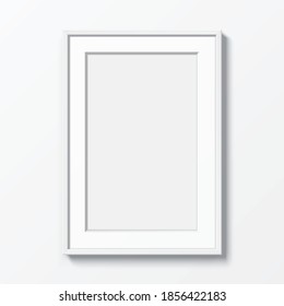 White vertical frame with Passepartout hanging on a white wall. Blank elegant frame template, with clear space, for image or text placement. Rectangular shape picture frame, realistic vector mockup.