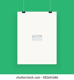 White vertical poster template hanging on clips, isolated on a green background. Poster realistic mokcup.