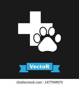 White Veterinary clinic symbol icon isolated on black background. Cross hospital sign. A stylized paw print dog or cat. Pet First Aid sign.  Vector Illustration
