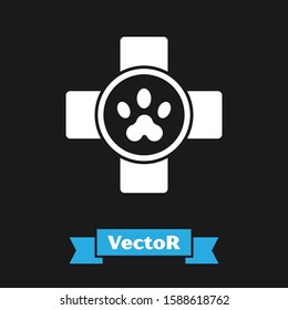White Veterinary clinic symbol icon isolated on black background. Cross hospital sign. Stylized paw print dog or cat. Pet First Aid sign.  Vector Illustration