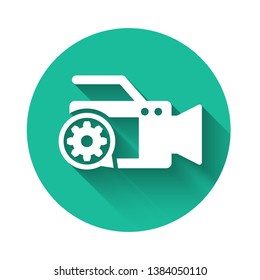 White Video camera and gear icon isolated with long shadow. Adjusting app, service concept, setting options, maintenance, repair, fixing. Green circle button. Vector Illustration