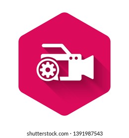 White Video camera and gear icon isolated with long shadow. Adjusting app, service concept, setting options, maintenance, repair, fixing. Pink hexagon button. Vector Illustration