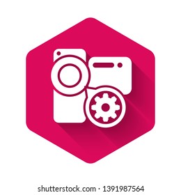 White Video camera and gear icon isolated with long shadow. Adjusting app, service concept, setting options, maintenance, repair, fixing. Pink hexagon button. Vector Illustration