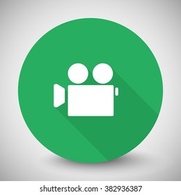 White Video Camera icon with long shadow on green circle