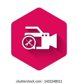 White Video camera with screwdriver and wrench icon isolated with long shadow. Adjusting, service, setting, maintenance, repair, fixing. Pink hexagon button. Vector Illustration