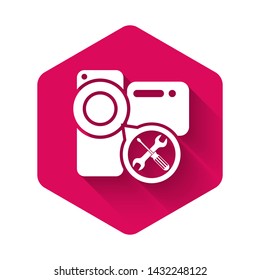White Video camera with screwdriver and wrench icon isolated with long shadow. Adjusting, service, setting, maintenance, repair, fixing. Pink hexagon button. Vector Illustration