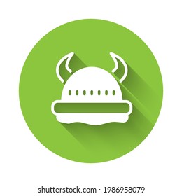 White Viking in horned helmet icon isolated with long shadow. Green circle button. Vector