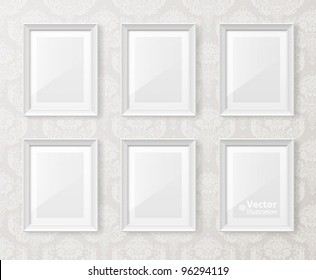 White vintage interior with frames on the wall.