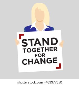 White woman in business suit holding protest sign