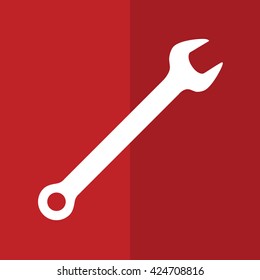 White wrench tool icon. Red background