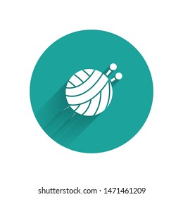White Yarn ball with knitting needles icon isolated with long shadow. Label for hand made, knitting or tailor shop. Green circle button. Vector Illustration