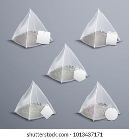 Whole leaves silky nylon pyramid realistic tea bags collection with various shaped white blank tags vector illustration 