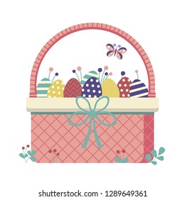 Wicker Easter basket filled with colored ornamented eggs, flowers, leafs, twigs, berries and other egg hunt symbols. Spring festive traditional straw basket icon.