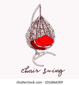 Wicker hanging chair swing hanging on a chain with red cushions