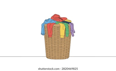 Wicker laundry basket filled with various colorful clothes on a clean white background.