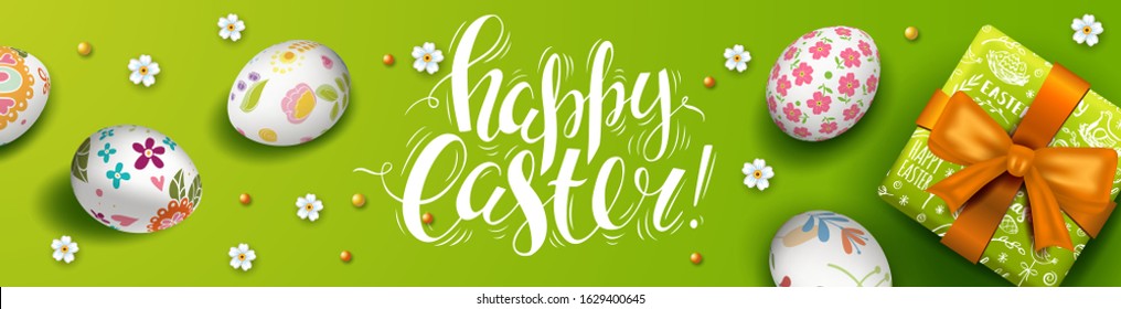 Wide Easter banner with 3D realistic colorful eggs and gift box. Hand Lettering Happy Easter. Green vector background and white flowers.