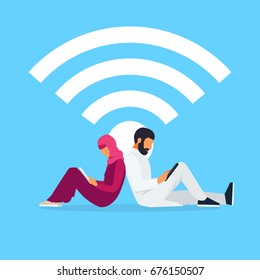 Wi-Fi concept. Young Muslim couple sit back to back and read using a tablet pc. Arab men and women in traditional clothes use laptops. Vector illustration.