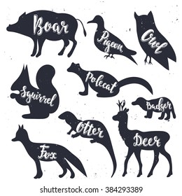 Wild animals silhouettes with lettering: boar, pigeon, owl, squirrel, polecat, badger, otter, fox, deer. Isolated Vector Illustration