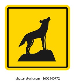 Wild animals yellow road sign. Silhouette of howling wolf