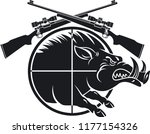 wild boar in gun scope crosshair sight and crossed hunting rifles