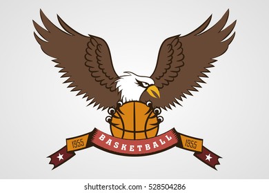 wild eagle with the ball in his paws. sports the emblem of the basketball team. logo, icon. ribbon with the inscription. 