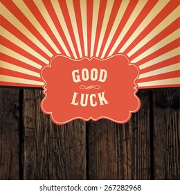 Wild west styled "Good Luck" message on wooden board. With red rays background