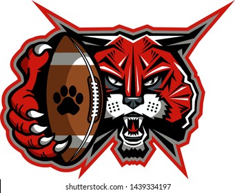 wildcat football mascot holding ball in claw for school, college or league