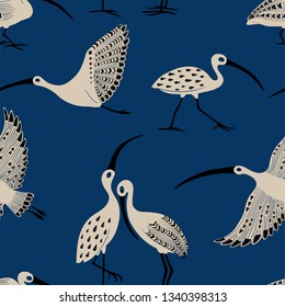 Wildlife birds print. Seamless pattern with folk art ornate ibis on a blue background.