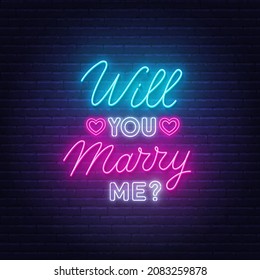 Will You Marry Me neon lettering on brick wall background.