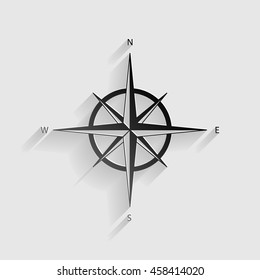 Wind rose sign. Black paper with shadow on gray background.