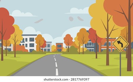 Winding empty road leads towards a suburban neighborhood lined with vibrant orange and yellow trees in autumn.