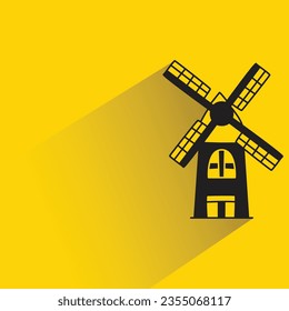 windmill with shadow on yellow background