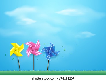 Windmills blowing in the wind on blue sky. Paper art and craft style
