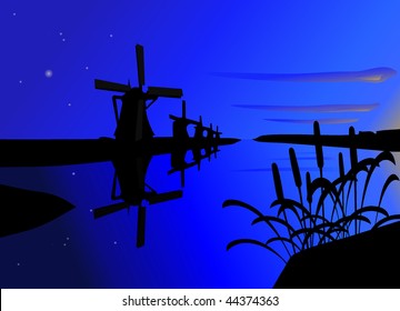 Windmills, standing along the river at dawn