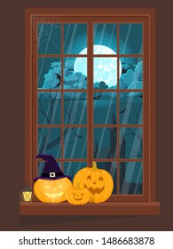Window decorated for Halloween with pumpkins.