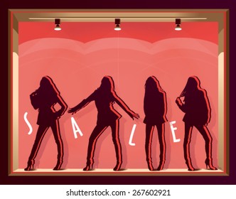 window display with mannequins and text SALE on a pink background