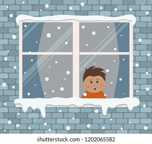 Window on a brick wall on a snowy day. A little boy in the room is surprised, looking at the snow. View from the street side. Winter background. Vector illustration.