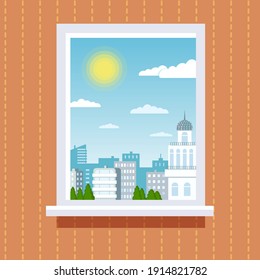 A window from a room in which it is a sunny day with a cityscape with houses.
