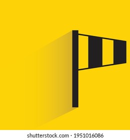 windsock indicator with shadow on yellow background