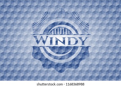 Windy blue badge with geometric background.
