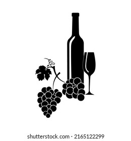 A wine bottle and glass with bunch of grapes and vine leaves.