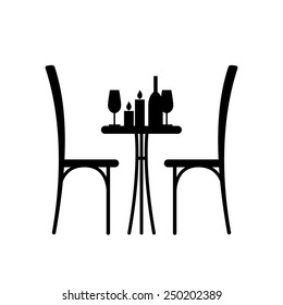 Wine and candles on the table and chair silhouette. Silhouette of a table in a cafe. Table with wine and glass and with a chairs beside him. Interior of the cafe. Table in the restaurant for two.