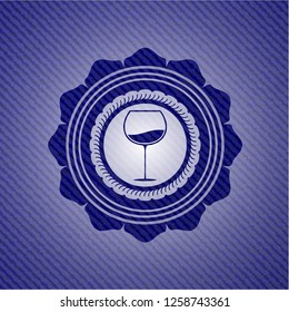 wine cup icon inside badge with denim background