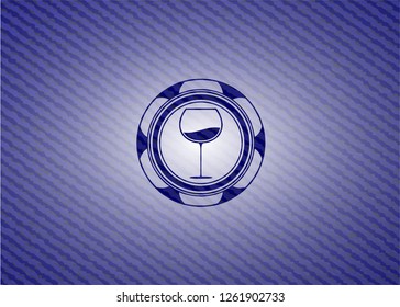 wine cup icon inside badge with denim texture