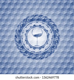 wine cup icon inside blue emblem or badge with abstract geometric polygonal pattern background.