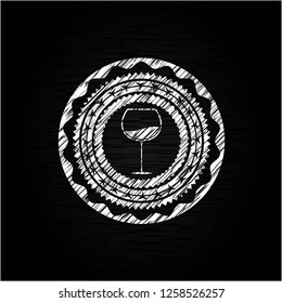 wine cup icon inside chalkboard emblem written on a blackboard