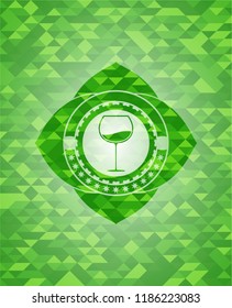 wine cup icon inside green emblem with mosaic background